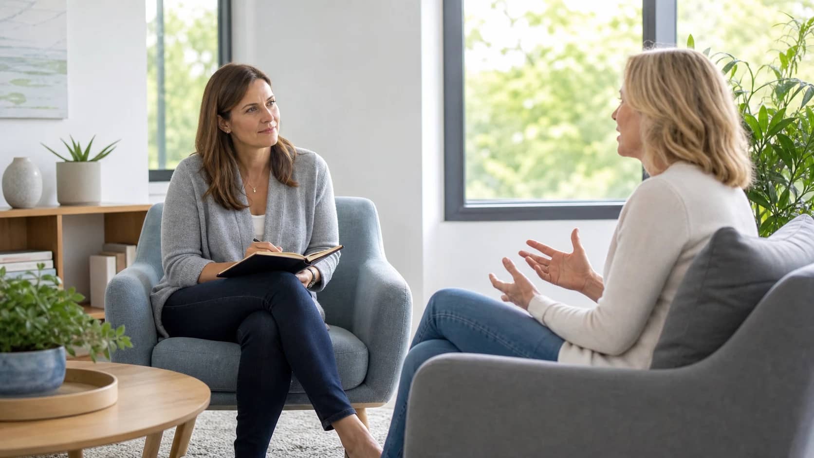 A mental health therapist and client in a naturally lit counselling session
