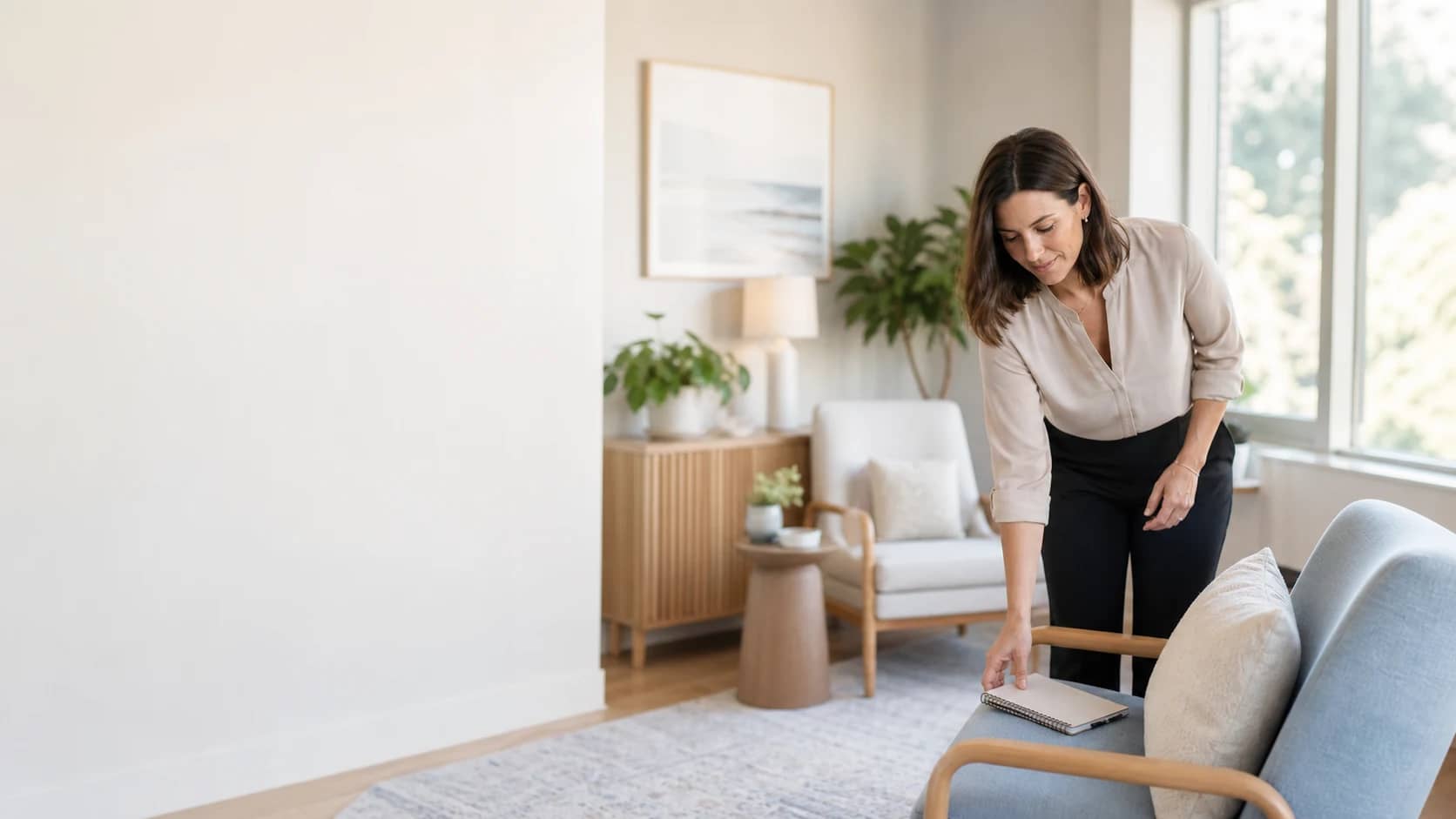 A mental health therapist listening to a client in a bright, calm counselling room